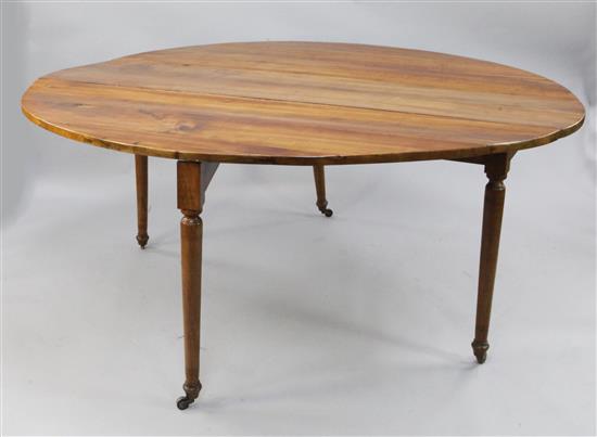 A large 19th century oval fruitwood drop leaf table, extended 6ft 1in. x 4ft 11.5in.
